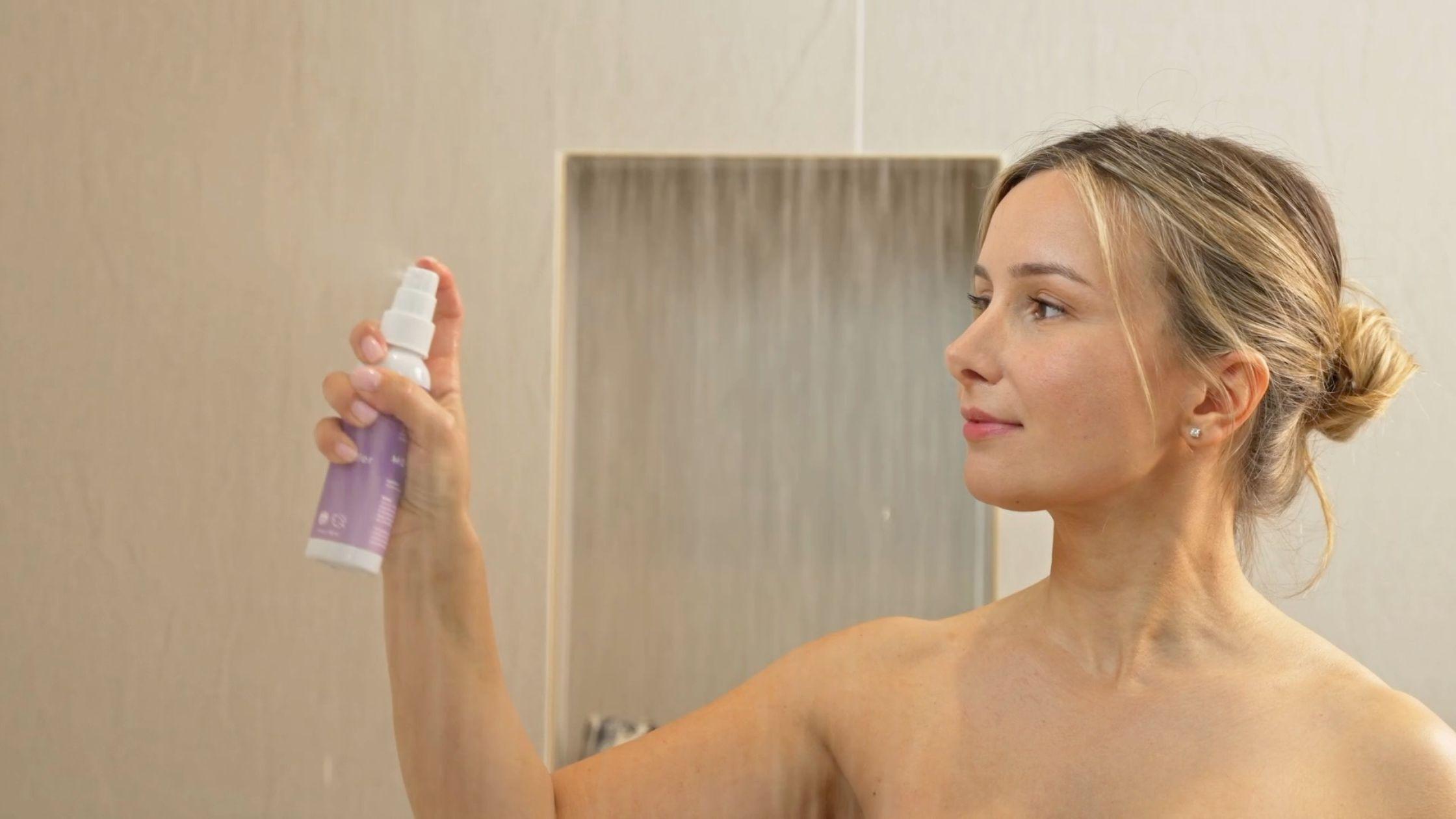 Woman using a MOXĒ Lavender Shower Spray in shower